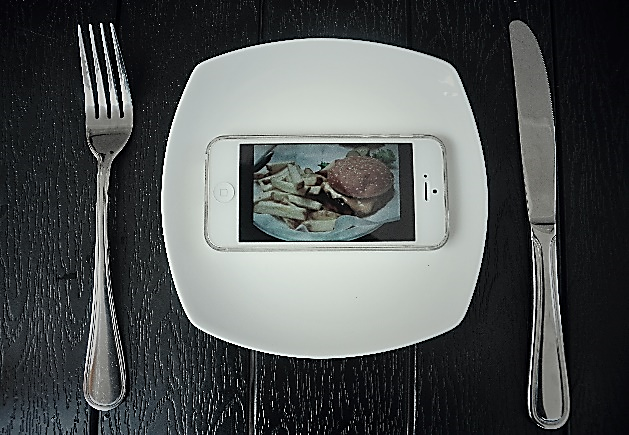 a turned-on cell phone is placed on a plate