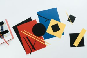 Geometric shapes cut from coloured paper.